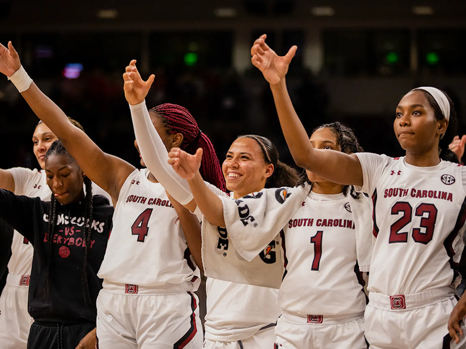 The women’s basketball team smiles and lifts their “cups” in celebration after defeating Clemson by over 30 points.