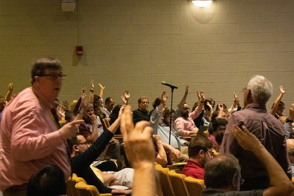 <p>Nursing Professor and Faculty Senator Abbas Tavakoli helps Parliamentarian Bill Sudduth tally votes in favor of an amendment during a faculty senate on April 19, 2023, in the Booker T. Washington Auditorium. The amendment failed by a vote of 33 for and 41 against. &nbsp;</p>