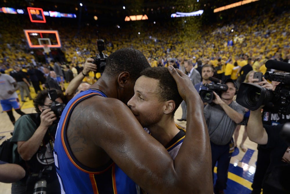 Golden State Warriors' Stephen Curry (30) is congratulated by Oklahoma City Thunder's Kevin Durant (35) after defeating the Oklahoma City Thunder in Game 7 of the NBA Western Conference finals at Oracle Arena in Oakland, Calif., on Monday, May 30, 2016. Golden State defeats Oklahoma City 96-88. (Jose Carlos Fajardo/Bay Area News Group/TNS)