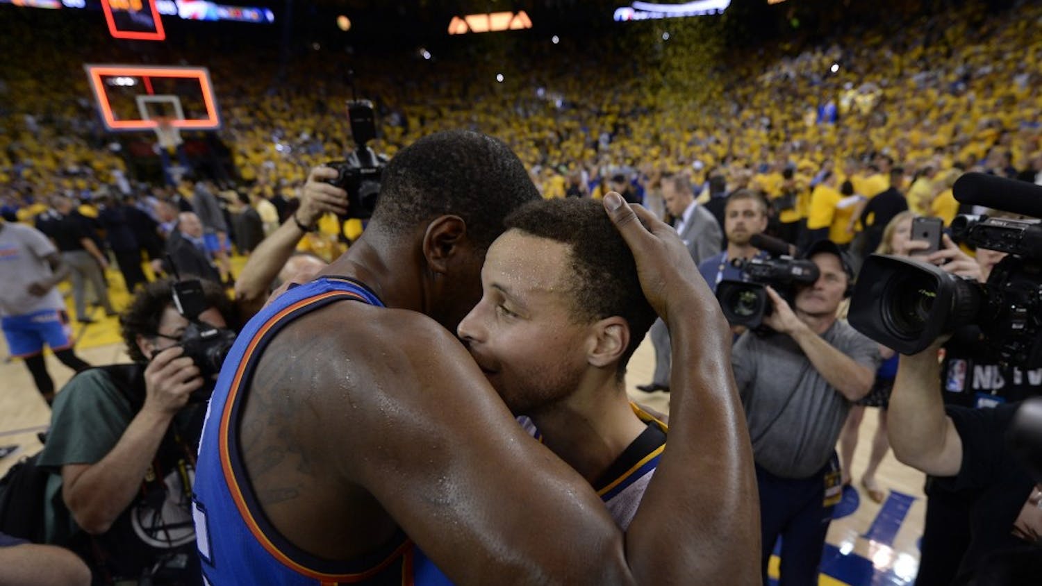 Golden State Warriors' Stephen Curry (30) is congratulated by Oklahoma City Thunder's Kevin Durant (35) after defeating the Oklahoma City Thunder in Game 7 of the NBA Western Conference finals at Oracle Arena in Oakland, Calif., on Monday, May 30, 2016. Golden State defeats Oklahoma City 96-88. (Jose Carlos Fajardo/Bay Area News Group/TNS)