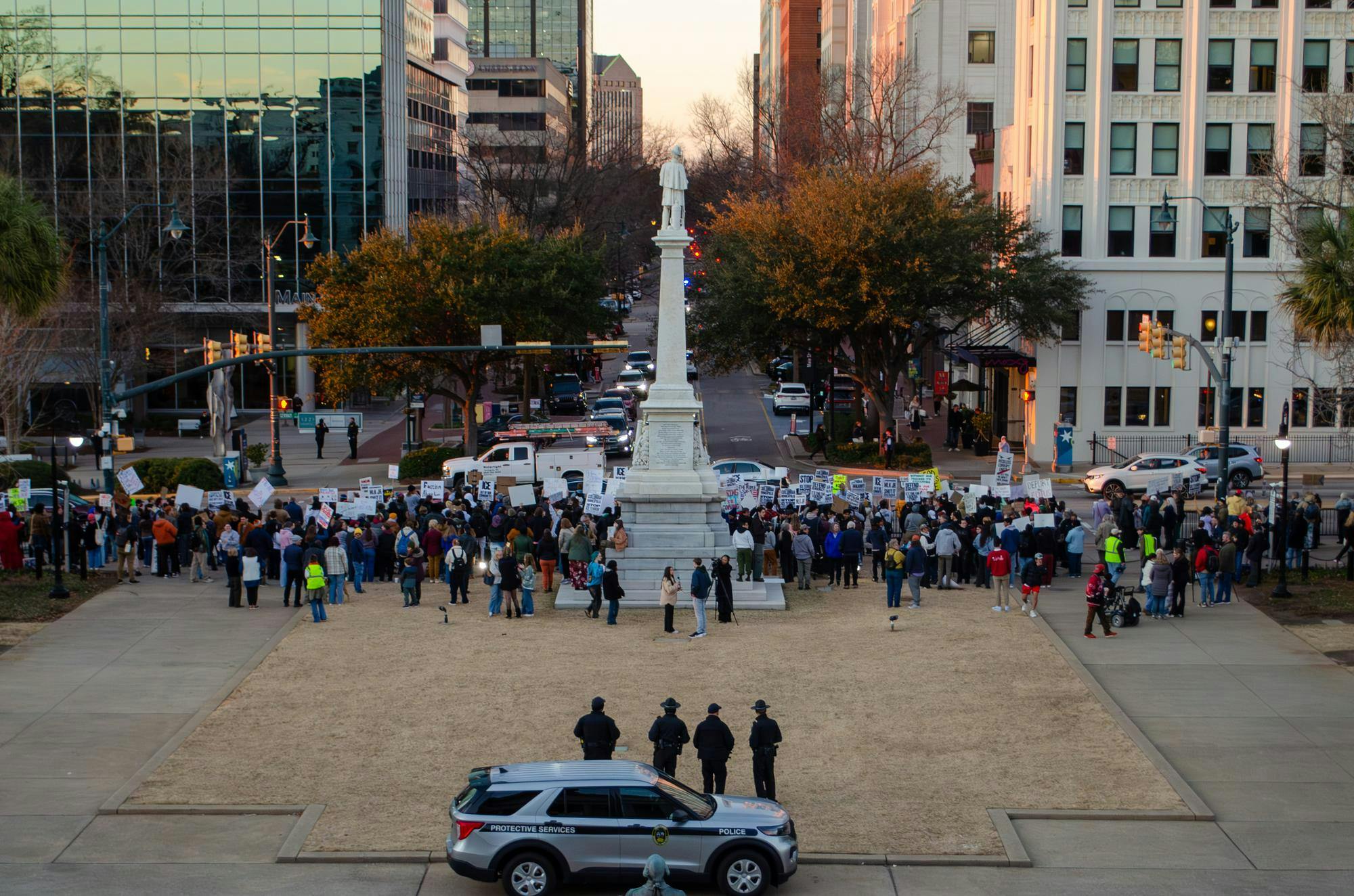 A crowd of protestors is observed by police at the statehouse in Columbia, South Carolina, on Jan. 20, 2026. The protesters, a large number of whom are students, hold signs opposing the actions of U.S. Immigration and Customs Enforcement.