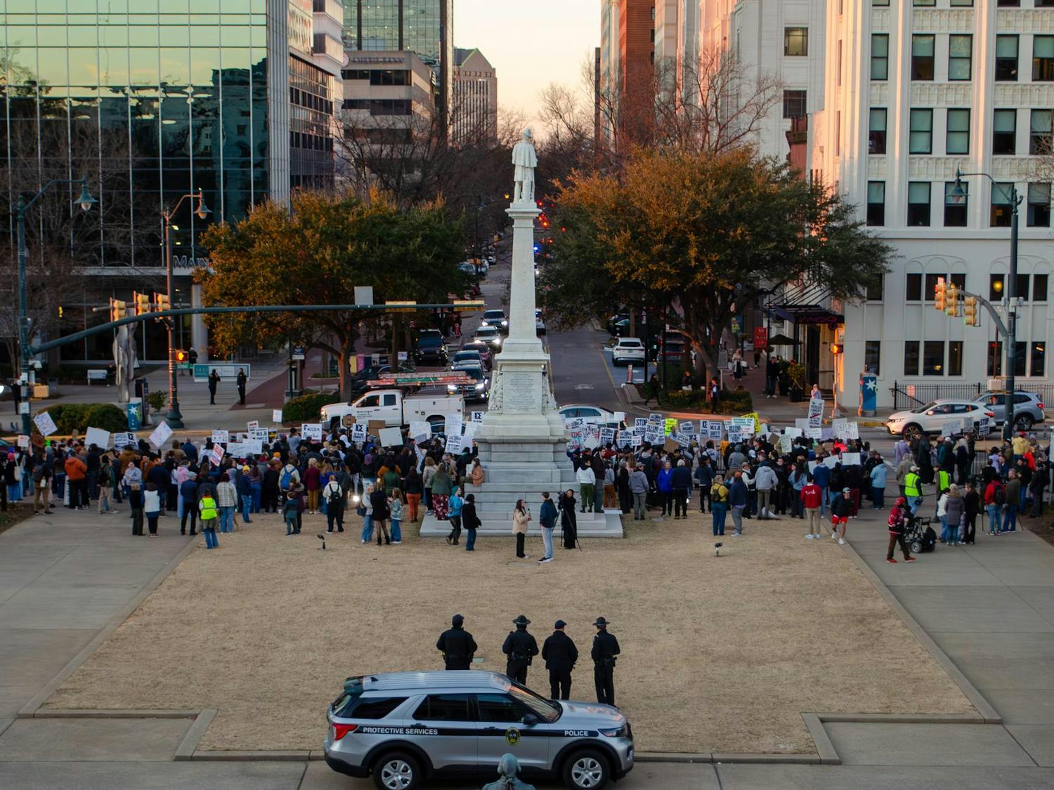 A crowd of protestors is observed by police at the statehouse in Columbia, South Carolina, on Jan. 20, 2026. The protesters, a large number of whom are students, hold signs opposing the actions of U.S. Immigration and Customs Enforcement.