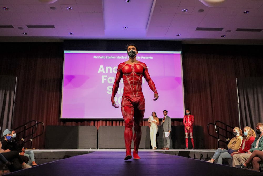 <p>FILE— A model, painted with the muscular system walks the runway at the Phi Delta Epsilon's annual Anatomy Fashion Show on Nov. 9, 2021. This annual event combines medical education with art to fundraise for the Children's Miracle Network.&nbsp;</p>