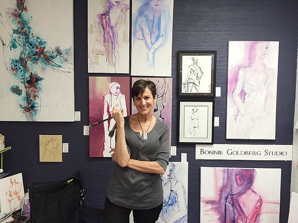 	<p>Bonnie Goldberg poses with her paintings at the Arcade Studios on Main Street, one of the nine locations of the annual Columbia Open Studios event hosted by 701 <span class="caps">CCA</span>.</p>
