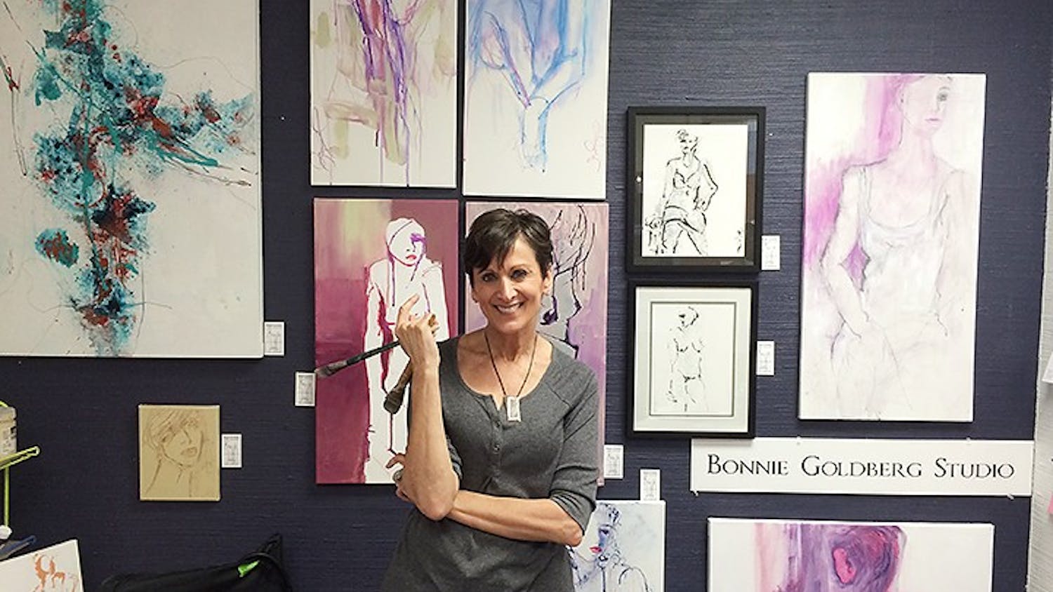 	Bonnie Goldberg poses with her paintings at the Arcade Studios on Main Street, one of the nine locations of the annual Columbia Open Studios event hosted by 701 CCA.