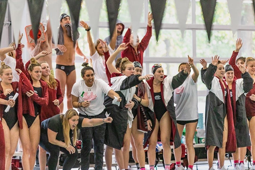 The UofSC swim and dive teams cheer as after a successful dive from one of their teammates on October 8, 2022. The women's swim and dive teams beat the Tigers 161.5-138.5, while the men's teams lost 143-157