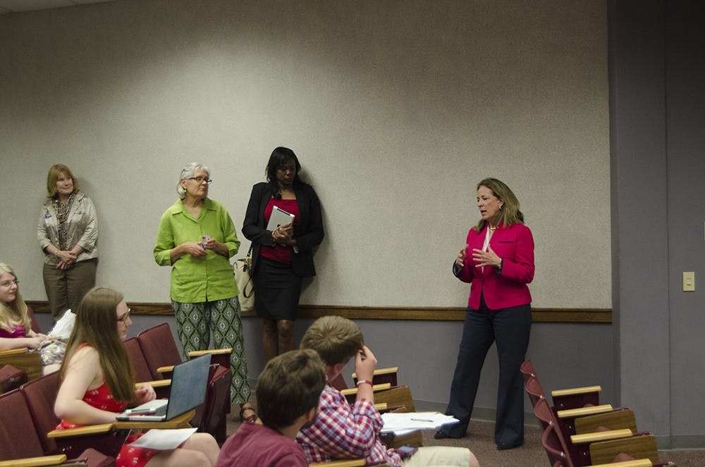 Elizabeth Colbert Busch talks to students making phone calls on behalf of her campaign.
