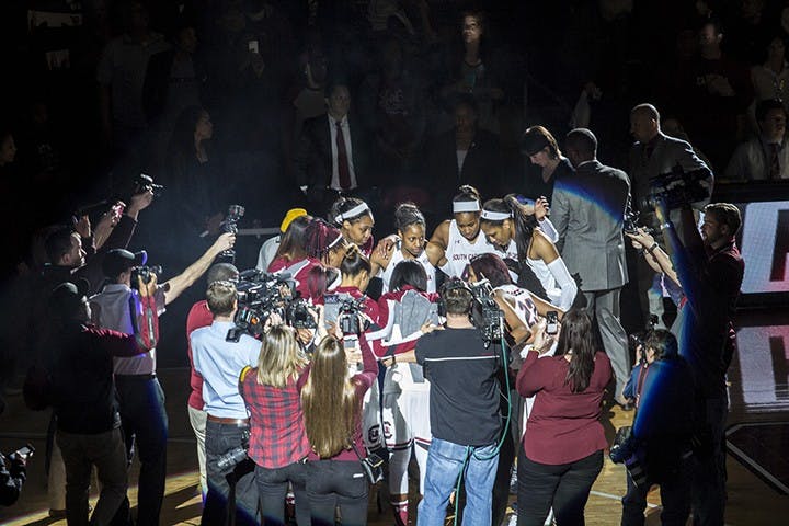 With media surrounding them, the team joins together one last time before the game begins. 