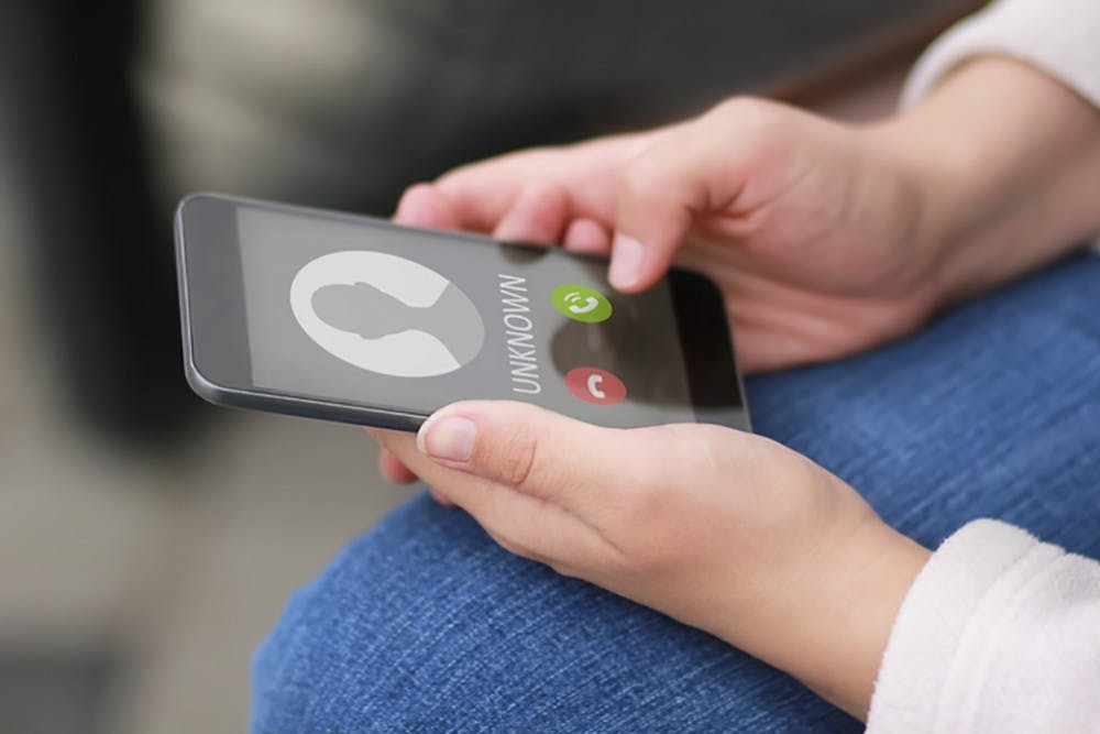 Close up of woman&apos;s hands with smartphone and unknown incoming phone call on it. (KSTU-TV/iStockphoto/TNS)