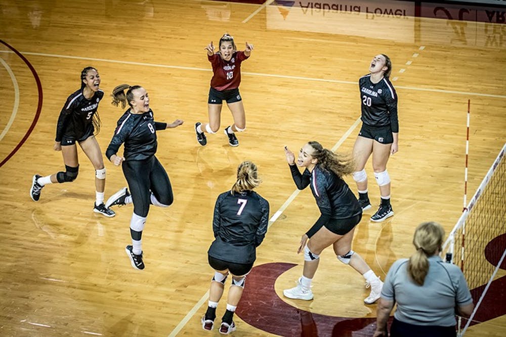 Members of the volleyball team celebrate a point. South Carolina came out with a 3-2 victory at Alabama Saturday afternoon.