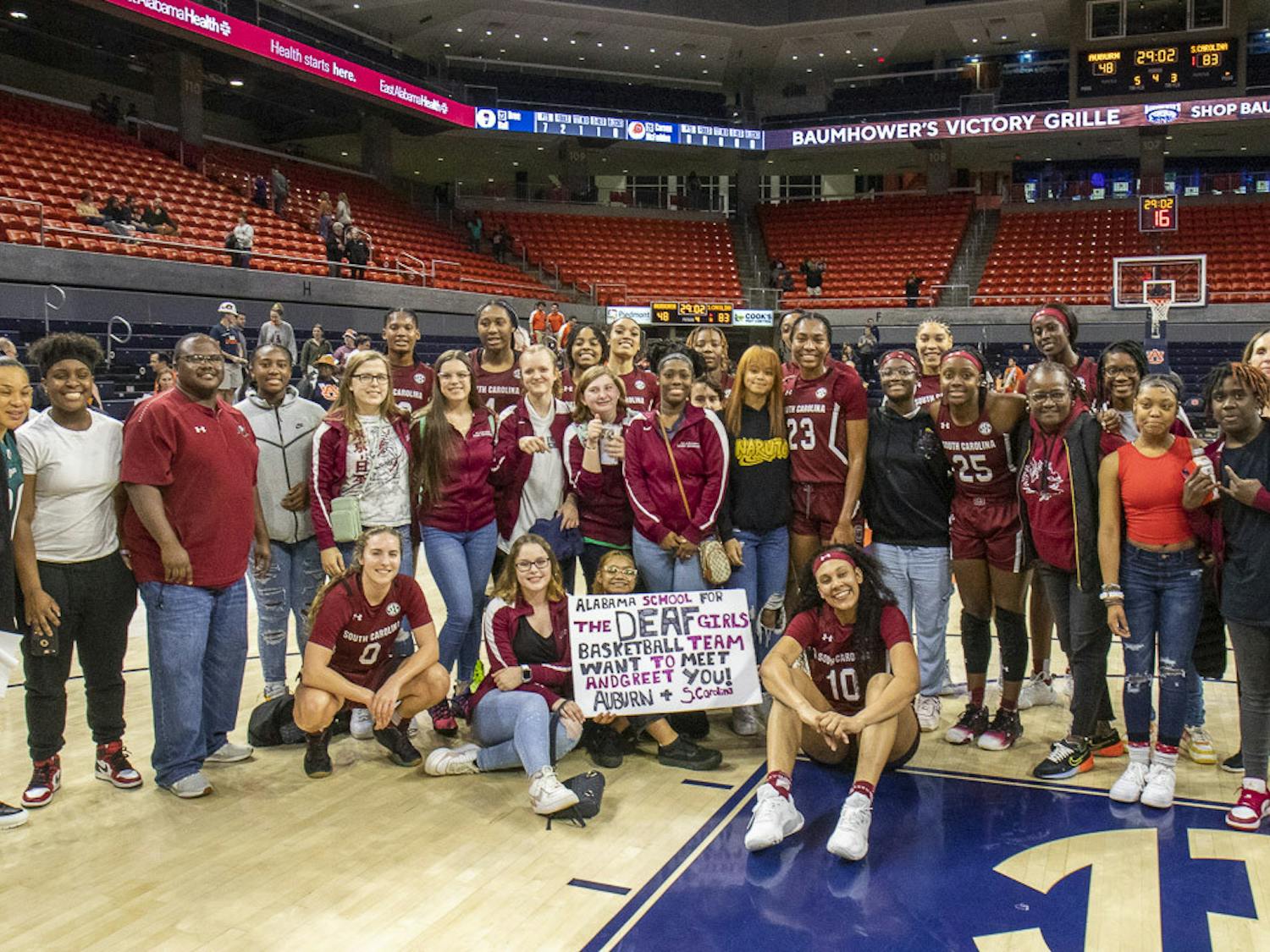 The Alabama School for the Deaf girl's basketball team poses with South Carolina's players, coaches and staff after the matchup against Auburn on Feb. 9, 2023. The Gamecocks beat the Tigers 83-48.&nbsp;