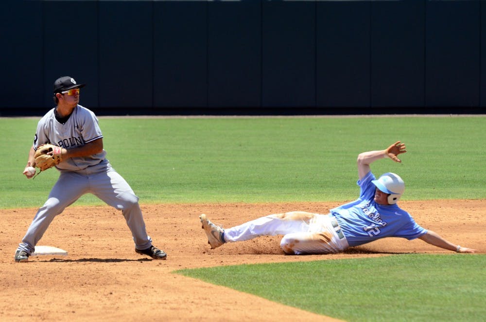 Schrock throws the ball to first base after tagging a runner out at second.