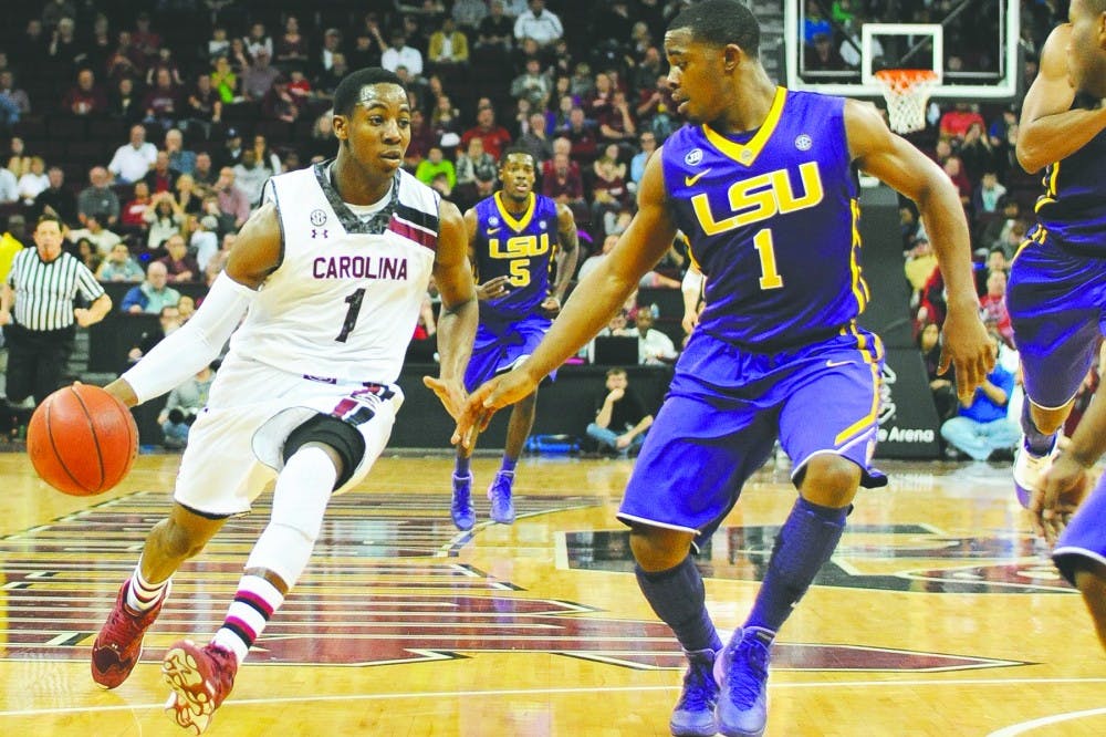 South Carolina&apos;s Brenton Williams, left, drives against Louisiana State&apos;s Anthony Hickey in the second half at Colonial Life Arena in Columbia, S.C., on Saturday, Jan. 11, 2014. LSU won, 71-68. (C. Michael Bergen/The State/MCT)
