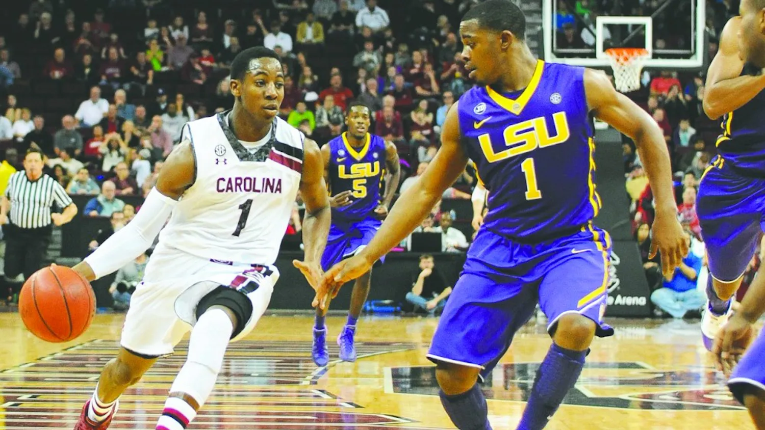 South Carolina's Brenton Williams, left, drives against Louisiana State's Anthony Hickey in the second half at Colonial Life Arena in Columbia, S.C., on Saturday, Jan. 11, 2014. LSU won, 71-68. (C. Michael Bergen/The State/MCT)