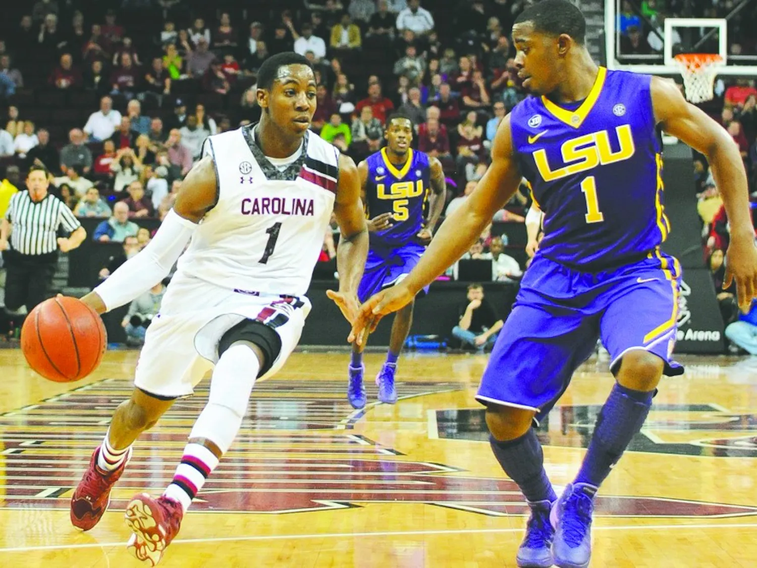 South Carolina's Brenton Williams, left, drives against Louisiana State's Anthony Hickey in the second half at Colonial Life Arena in Columbia, S.C., on Saturday, Jan. 11, 2014. LSU won, 71-68. (C. Michael Bergen/The State/MCT)