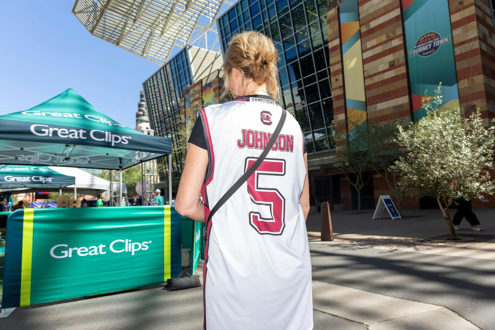 St. Michael, Minnesota, resident Brenda Ugalde shows off her Tessa Johnson shirt at Tourney Town during the Final Four on April 3, 2026 in Phoenix, Arizona. Ugalde said Johnson is the best player in the tournament and is excited to see both the Gamecocks and Huskies play live.