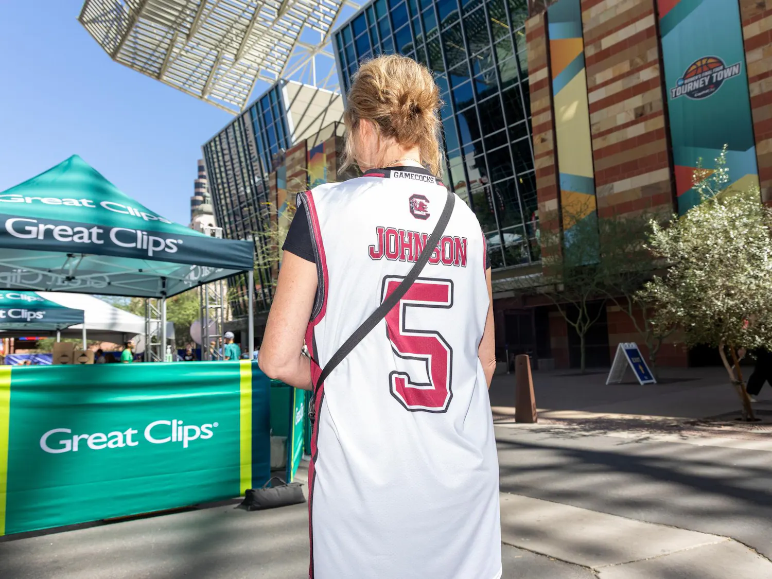 St. Michael, Minnesota, resident Brenda Ugalde shows off her Tessa Johnson shirt at Tourney Town during the Final Four on April 3, 2026 in Phoenix, Arizona. Ugalde said Johnson is the best player in the tournament and is excited to see both the Gamecocks and Huskies play live.