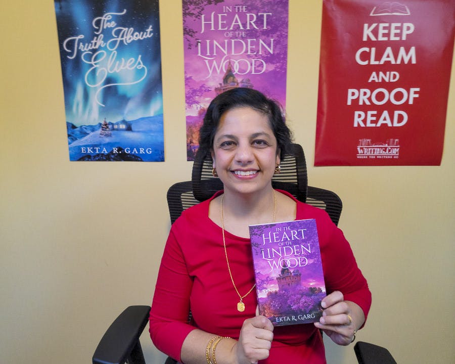 Ekta Garg poses in her office with her new book, "In the Heart of the Linden Wood," on Feb. 11, 2023. This is the second book that the USC alumna has published.