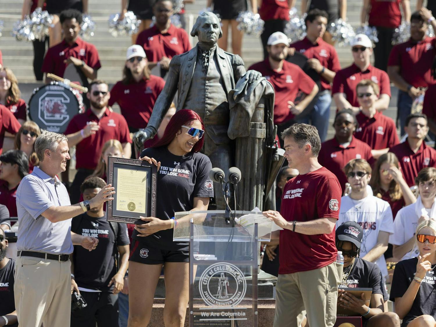 Gamecock women's basketball senior center Kamilla Cardoso accepts a proclamation from Columbia Mayor Daniel Rickenmann on the steps of the Statehouse on April 14, 2024. Rickenmann gave players and coaches with proclamations during the presentation that followed the celebratory parade for the national champions.