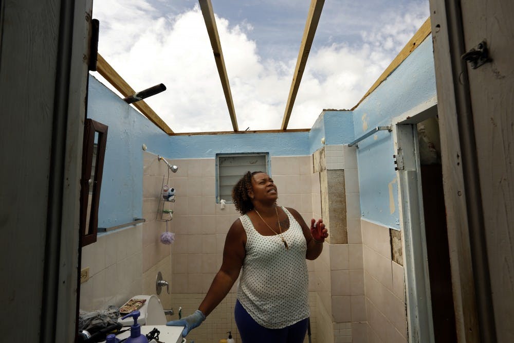 Adele Thomas is grateful that her family survived Hurricane Irma after it roared through her house, ripping the roof off and destorying all the contents. She is working to cover the roof with plastic, but the bathroom hasn't been covered yet, nor is there running water or electricity on Friday, Sept. 15, 2017. (Carolyn Cole/Los Angeles Times/TNS)