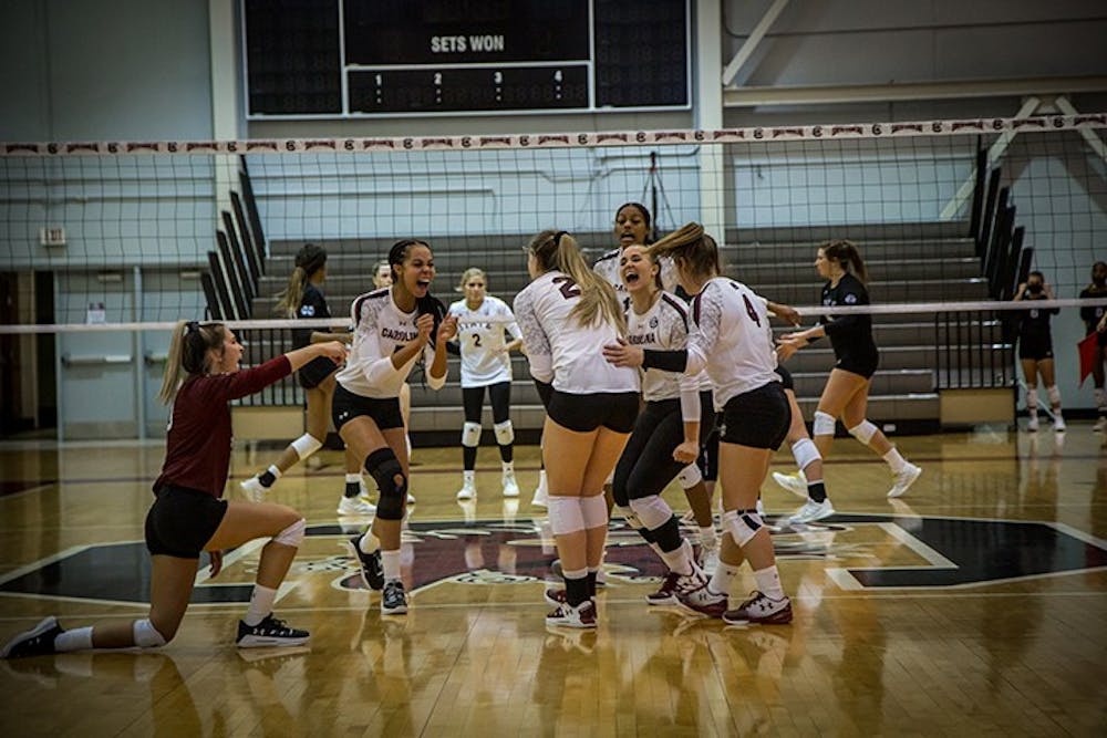 Members of the UofSC women's volleyball team celebrate after scoring a point against Mississippi State. The Gamecocks improved their record to 5-1 at home after the win.