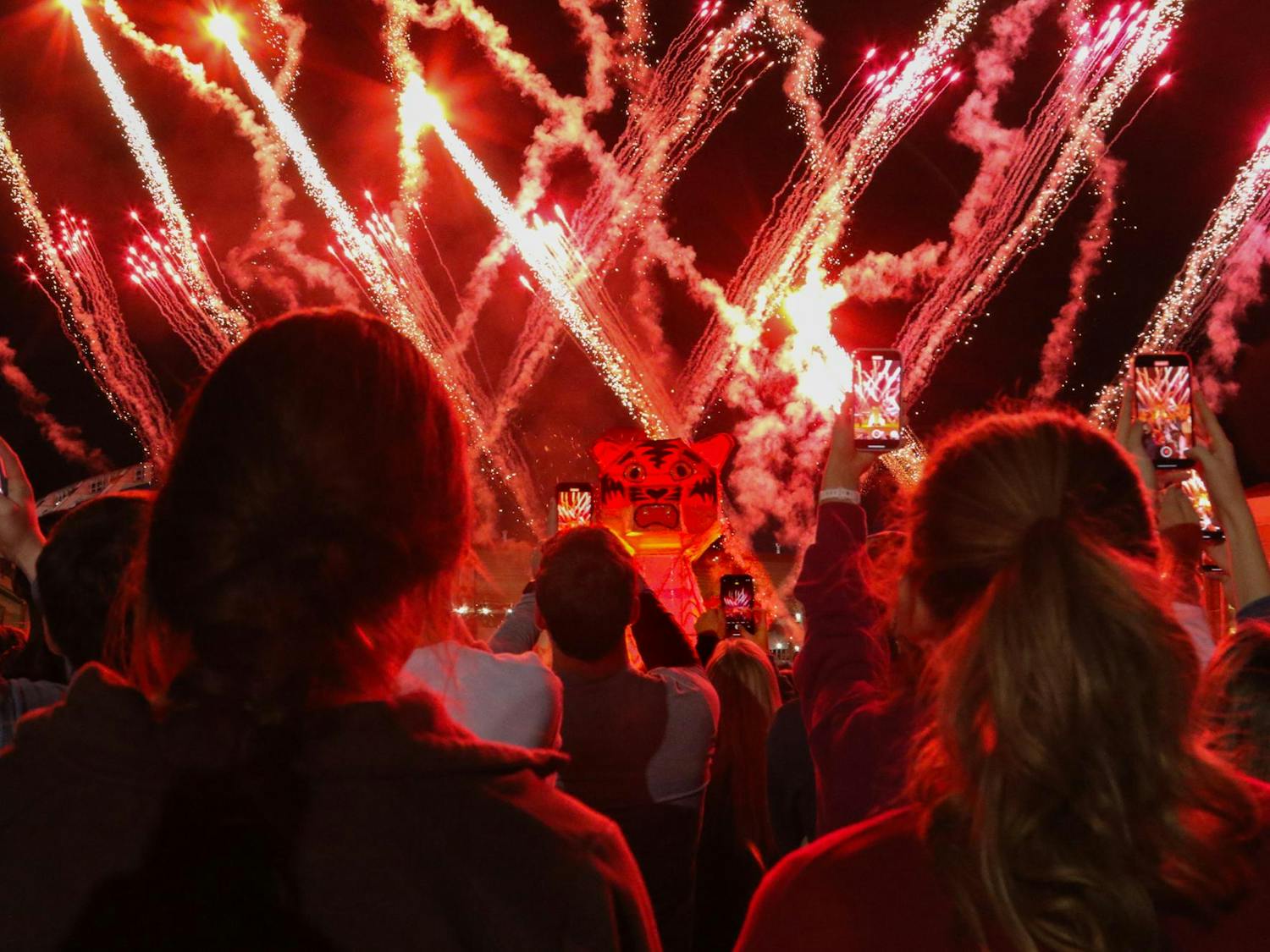 University of South Carolina students watch and record the wooden tiger go up in flames at the annual Tiger Burn celebration. The burning tiger was accompanied by fireworks and other festivities on Nov. 20, 2023.