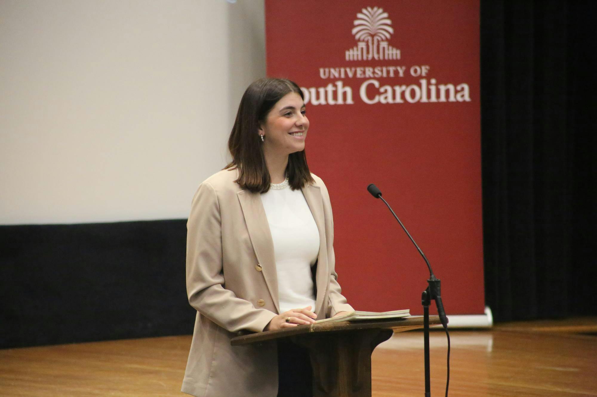 Student Body President Courtney Tkacs reports on the Stuff-a-Bus event and encourages the other senators to attend during the Student Body President Report period at the Russell House Theater on Nov. 5, 2025. Tkacs added that senators wanting to volunteer should bring non-perishable food items and wear their Student Government shirts.