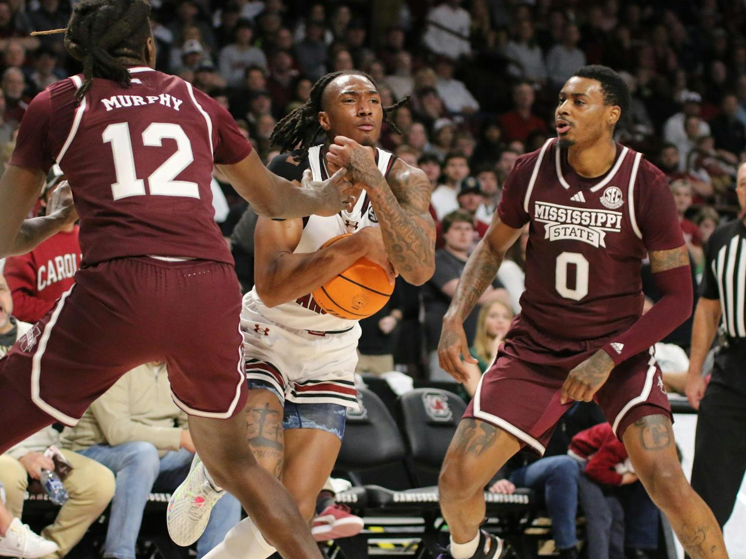 Sophomore guard Zachary Davis tucks the ball in to get past a double team on Jan. 6, 2024. Davis finished the game with 9 points, aiding the 68-62 win against Mississippi State.