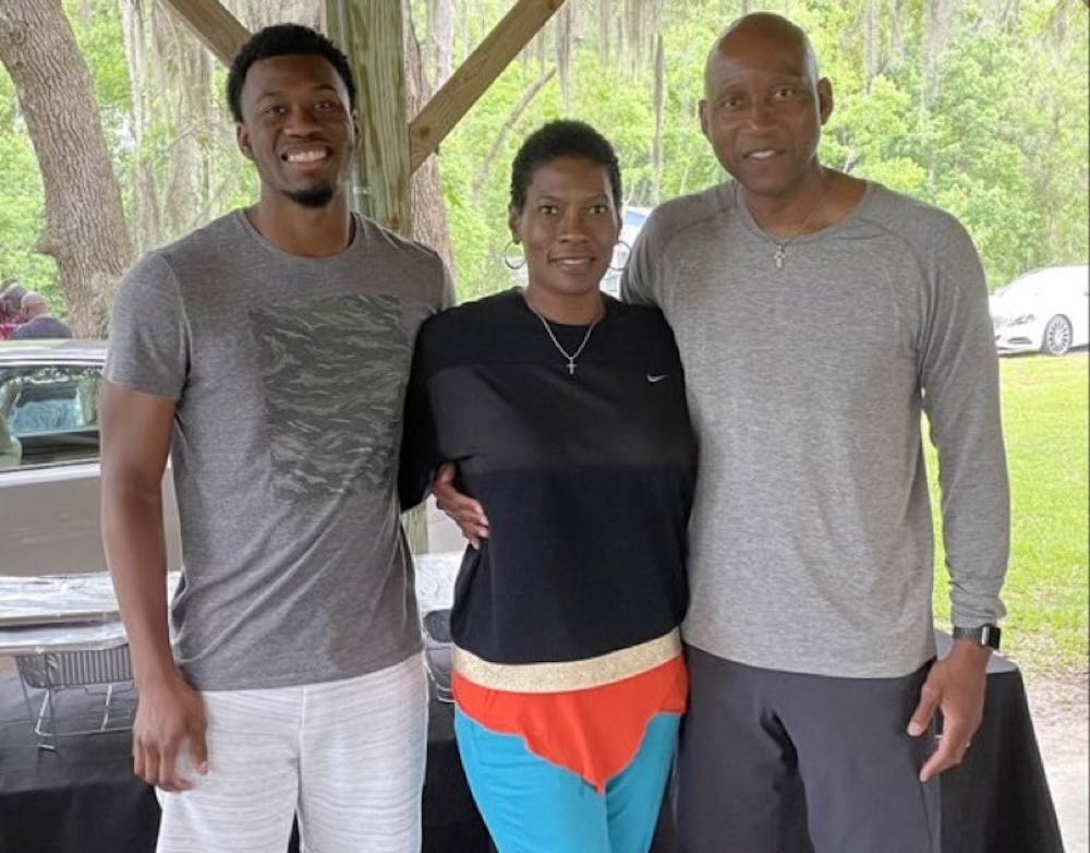 <p>USC Upstate men's basketball head coach Dave Dickerson Jr. poses with his son and his wife.&nbsp;</p>