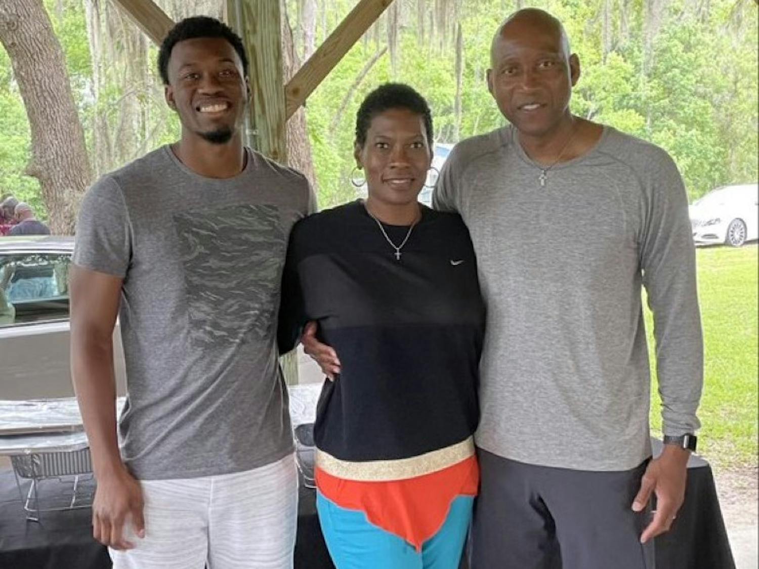 USC Upstate men's basketball head coach Dave Dickerson Jr. poses with his son and his wife. 