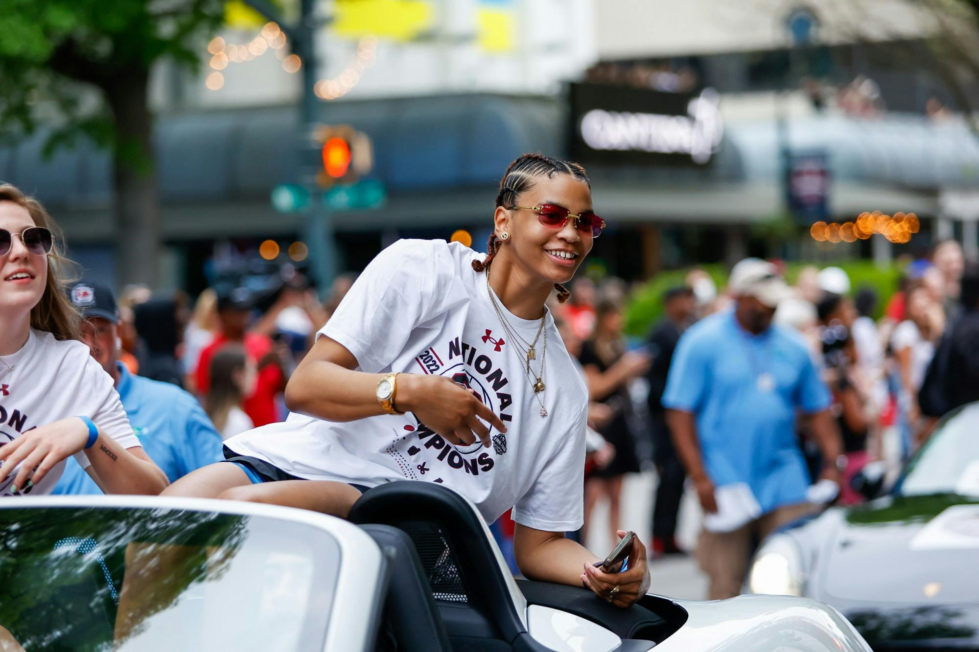 Senior forward Victaria Saxton waves from a car during a parade in honor of the Women’s Basketball team on April 13, 2022.&nbsp;
