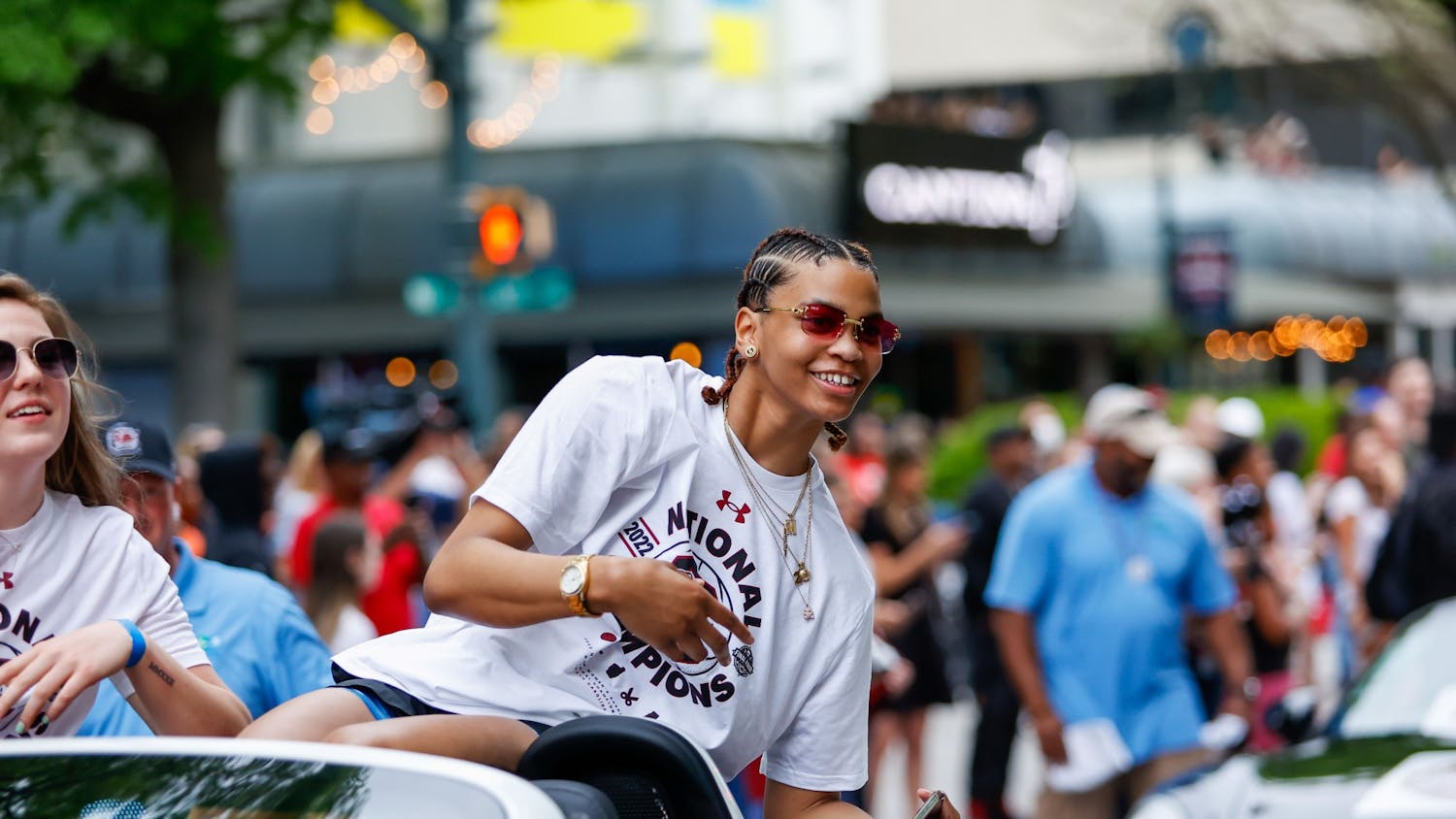 Senior forward Victaria Saxton waves from a car during a parade in honor of the Women’s Basketball team on April 13, 2022.&nbsp;