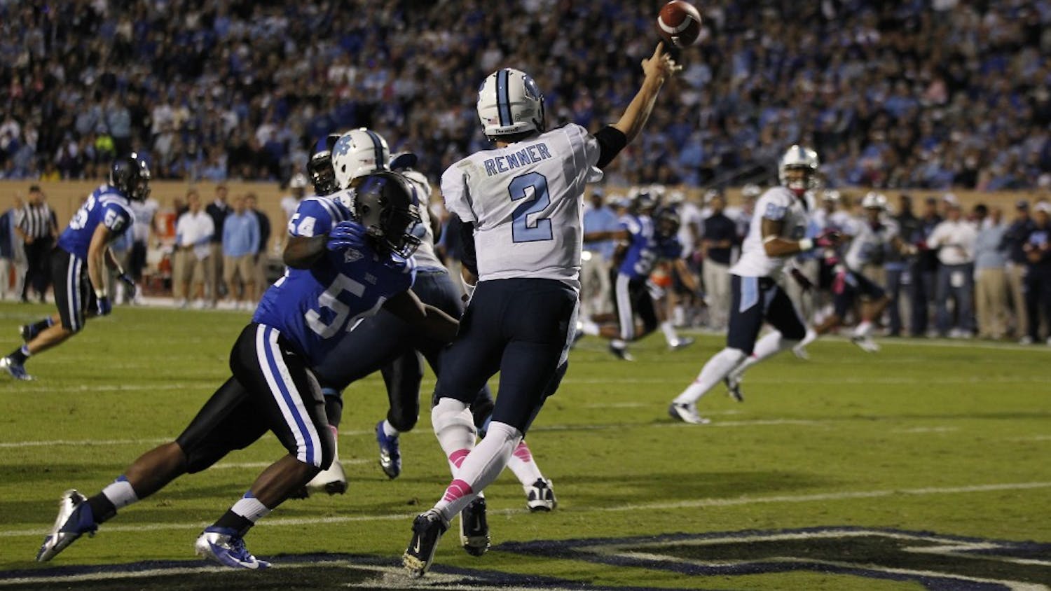 North Carolina quarterback Bryn Renner (2) gets rid of the ball from the end zone as Duke linebacker C.J. France (54) approaches on Saturday, October 20, 2012 at Wallace Wade Stadium in Durham, North Carolina. (Chuck Liddy/Raleigh News &amp; Observer/MCT)