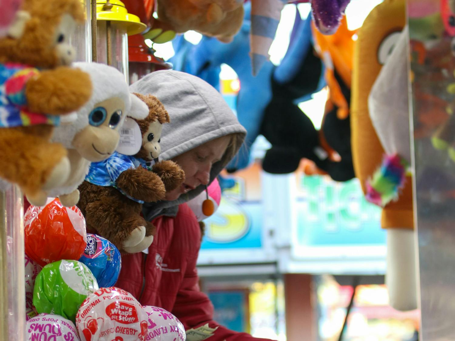 A carney collects money from a fair attendee before starting their water gun game on Oct. 21, 2022. The South Carolina State Fair is known for its vast selection of carnival games for patrons to play.
