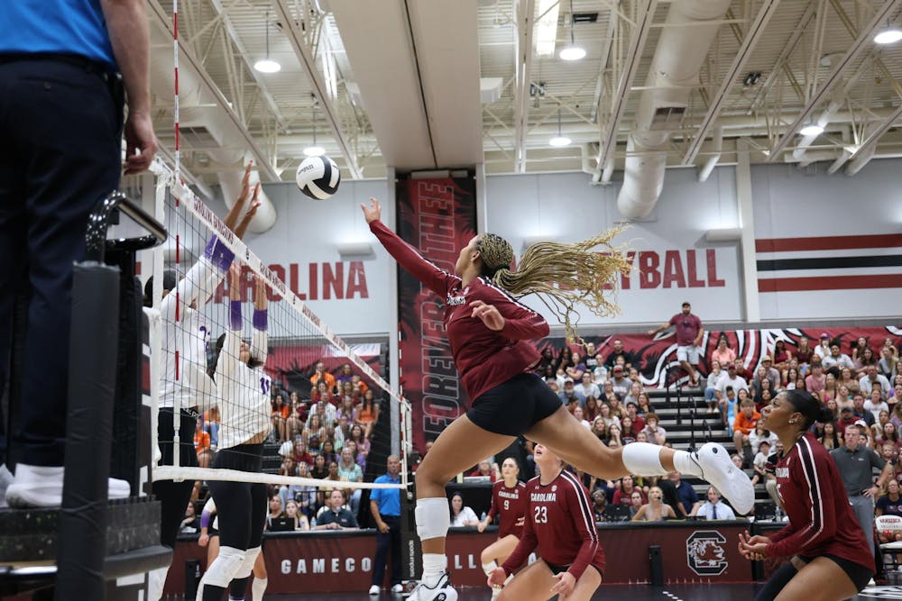 <p>Freshman outside hitter Victoria Hill tips the ball over defending players during the game against Clemson on Aug. 31, 2025. Hill has made 115 kills so far over the course of the 2025 season</p>