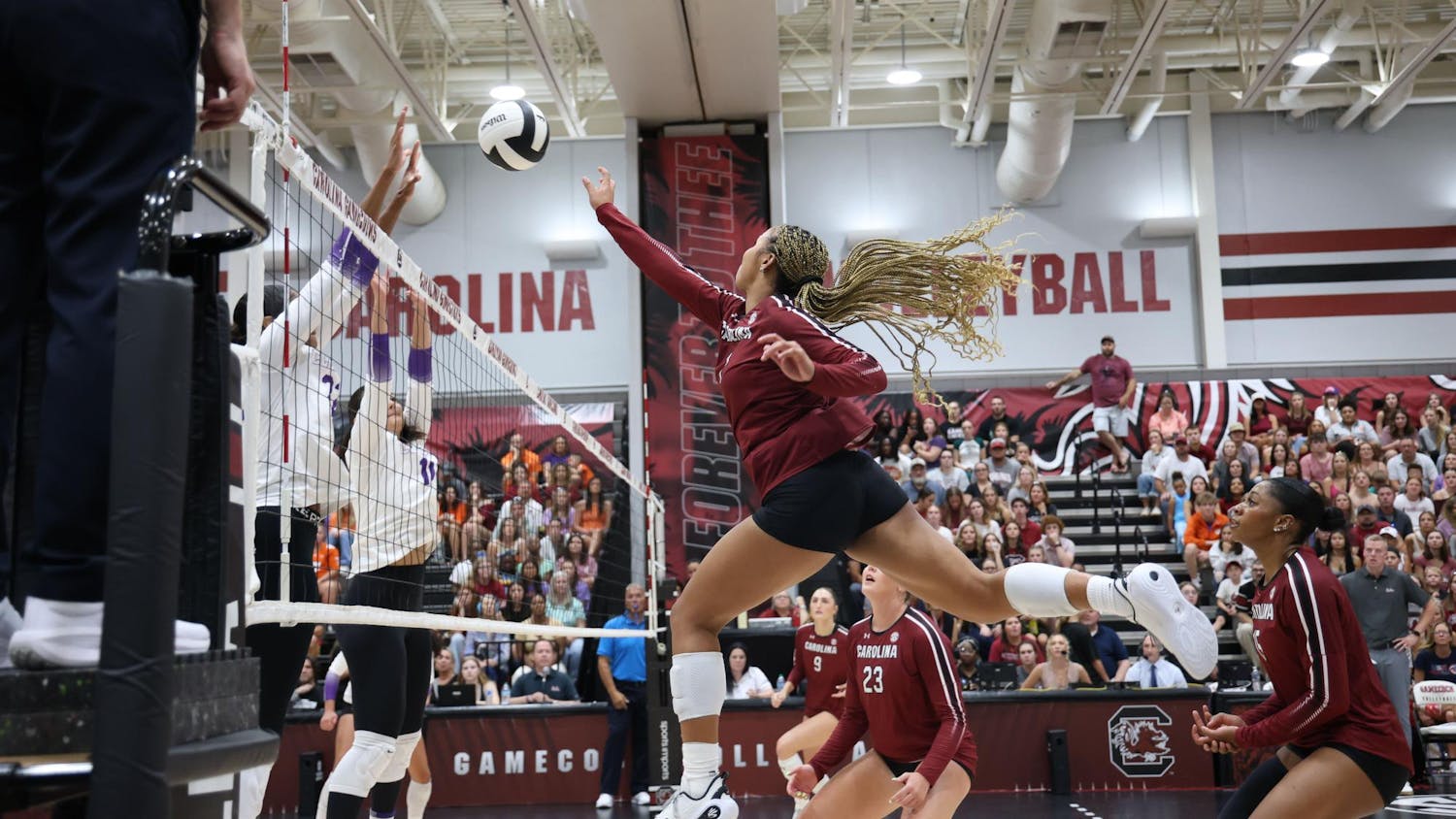 Freshman outside hitter Victoria Hill tips the ball over defending players during the game against Clemson on Aug. 31, 2025. Hill has made 115 kills so far over the course of the 2025 season