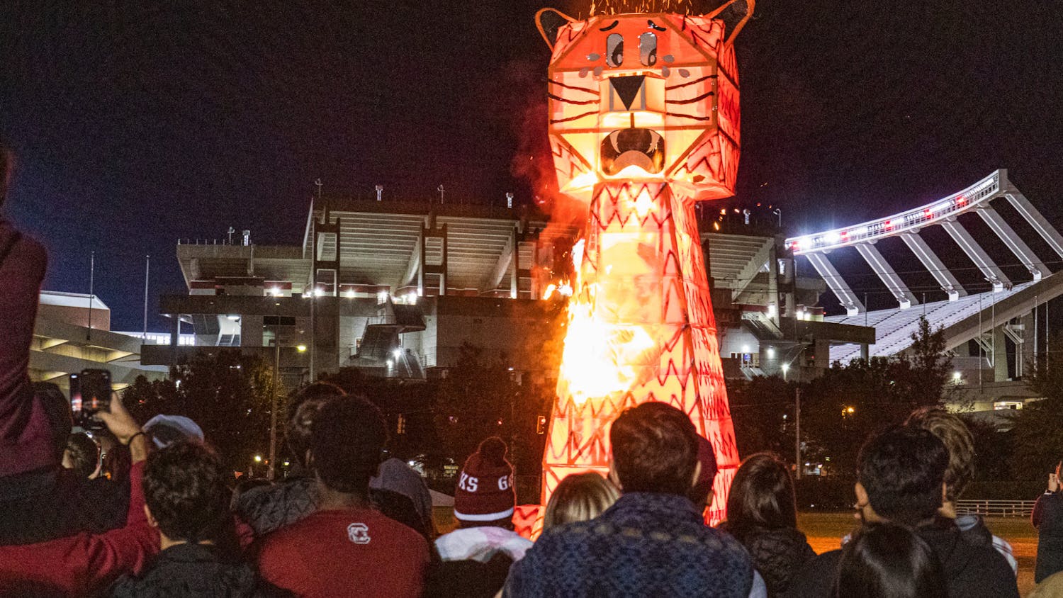 Students watch as a giant wood and steel-beam Tiger bursts in flames during the USC Tiger Burning Ceremony on Nov. 21, 2022. The Gamecocks went on to beat Clemson 31-30 for the first time since 2013.