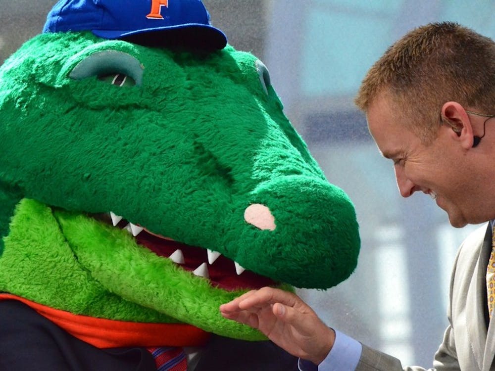 Lee Corso dons a Gator head during Saturday's episode of College GameDay, which broadcast from Gainesville, Fla.