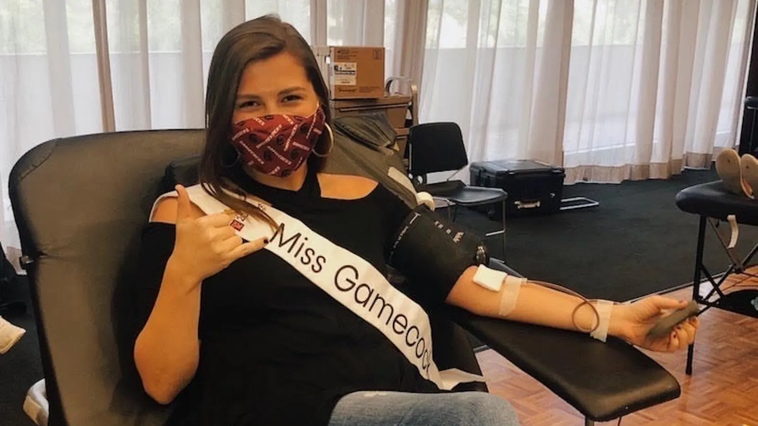 Miss Gamecock and third-year mass communications student Callie Farrell donates blood. 