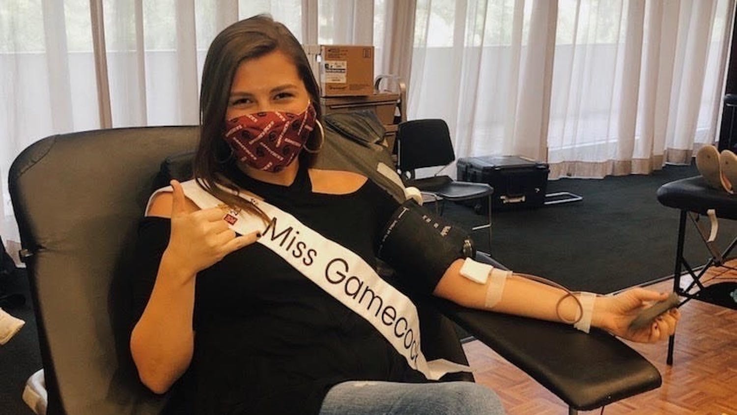 Miss Gamecock and third-year mass communications student Callie Farrell donates blood.&nbsp;
