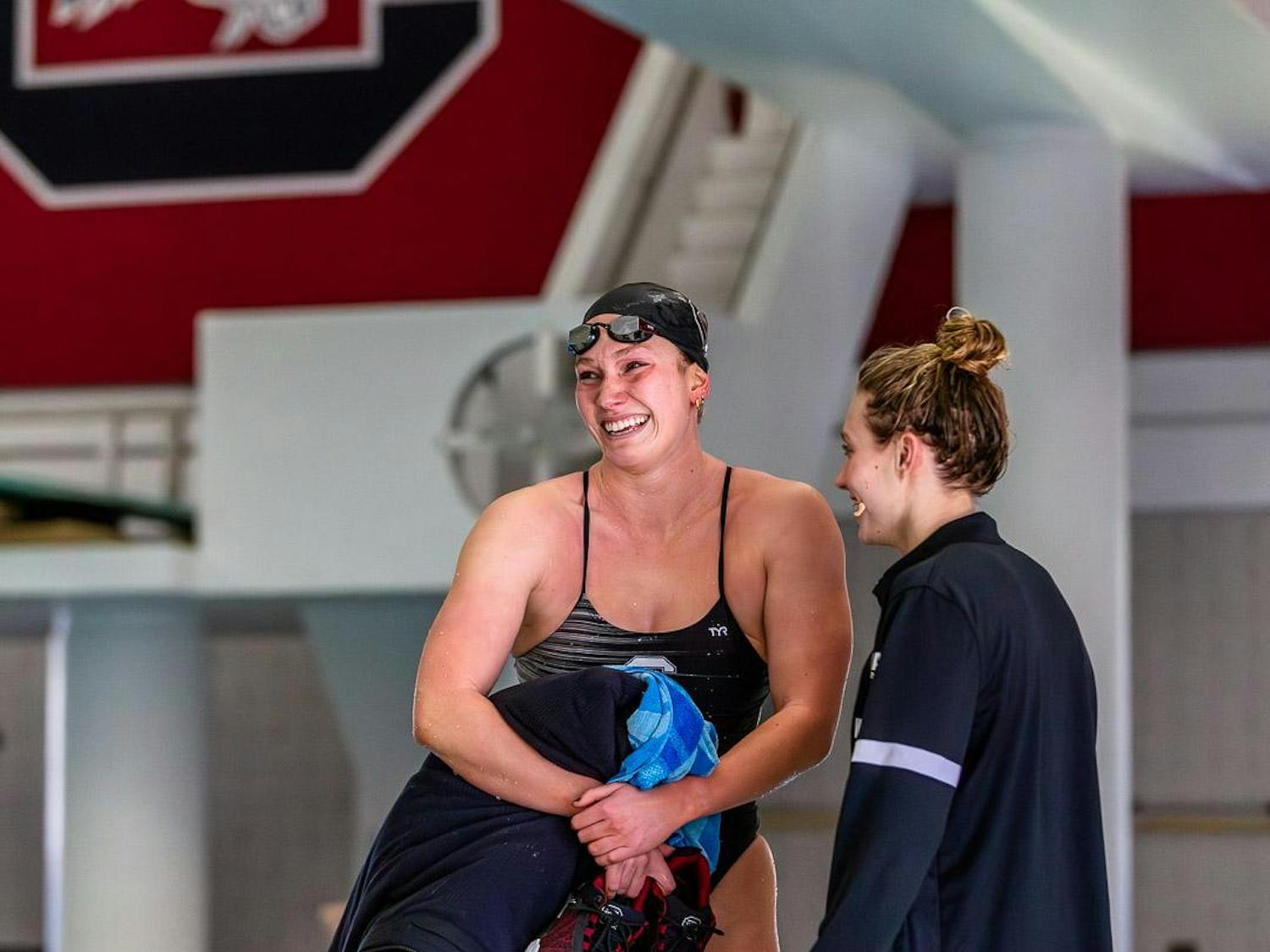 Senior Hayley Mason (left) tries to hold back tears after completing the 500-meter freestyle event against Duke University and UNC Asheville on Jan. 20, 2024. Mason and other senior team members expressed a range of emotions during their last competition at the Carolina Natatorium.