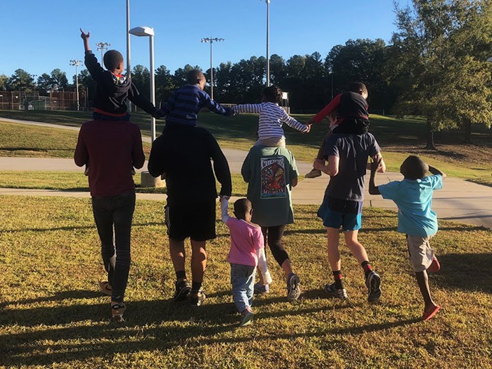 <p>&nbsp;Gamecocks Aiding Refugees in Columbia tutors running with students at a family fun day event, where they visited refugee communities and organized activities with the children.&nbsp;</p>