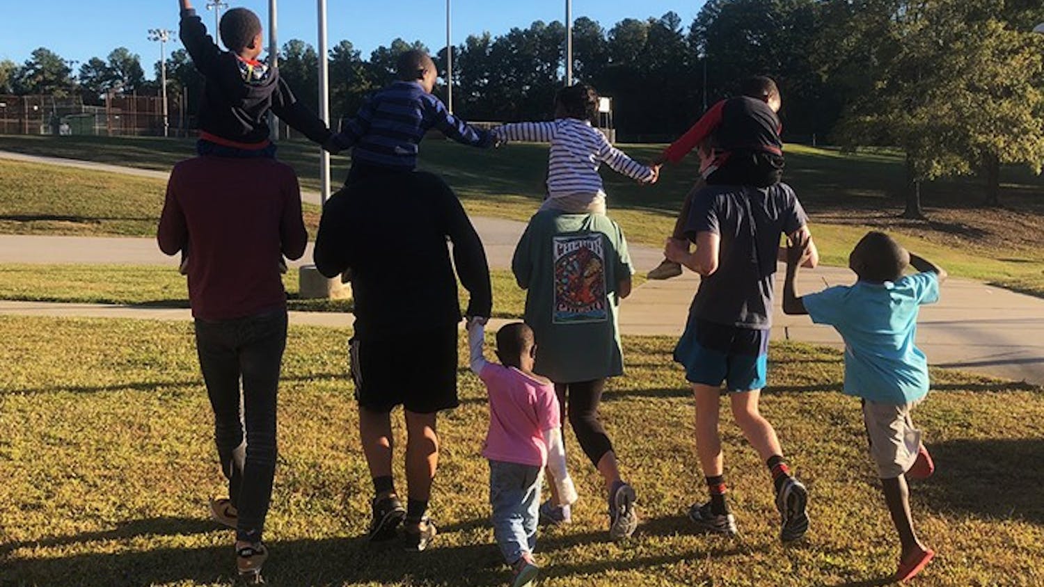  Gamecocks Aiding Refugees in Columbia tutors running with students at a family fun day event, where they visited refugee communities and organized activities with the children. 