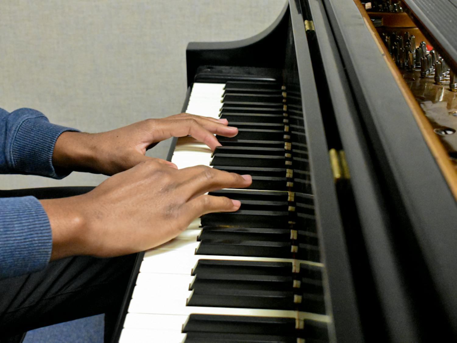 Second-year music industry studies student Donovan Medley rehearses on the classroom’s piano for the ensemble’s performance set for February 13, 2023. In professional music therapy settings, instruments are set up in a particular way for clients in order to be their most successful. They are deconstructed so that patients can learn the basics and grow as they practice.