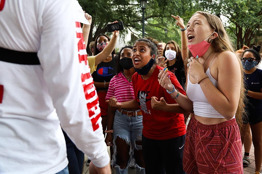 Isabella Jones and a fellow student yell in protest of Jim Gilles' presence on the university’s campus. These students combated remarks made by Jim Gilles, and many students yelled in agreement.