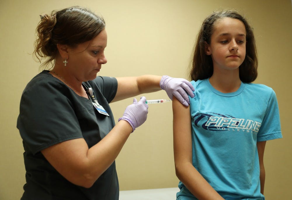 Nurse Laura Johnson administers a dose of the human papillomavirus (HPV) vaccine to Abby Major, 13, at an Amita Health clinic Tuesday, July 3, 2018, in Hoffman Estates, Ill. (John J. Kim/Chicago Tribune/TNS) 