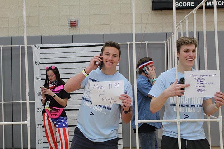 &nbsp;Mike Giordano, a freshmen finance major, calls for donations to free him from Dance Marathon’s makeshift jail.&nbsp;
