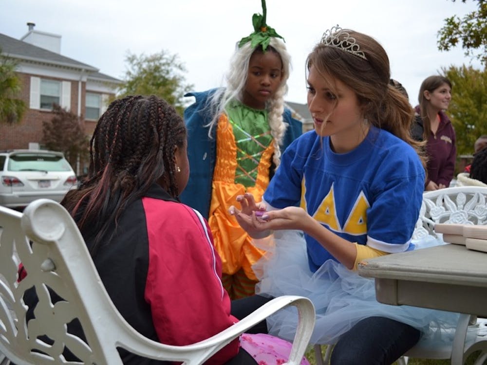 Hundreds of children take part in games and activities and trick-or-treat for candy in the Greek Village Tuesday afternoon.