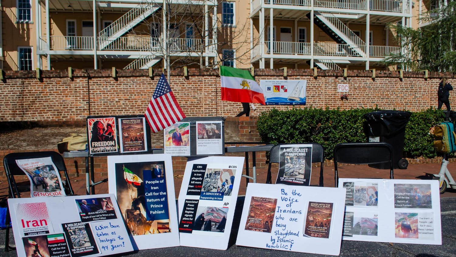 A demonstration in support of protestors in Iran takes place outside the Russell House on Greene Street in Columbia, South Carolina, on Jan. 15, 2026. Signs accuse the Islamic Republic of genocide and support the return of Crown Prince Reza Pahlavi, who is in exile in the United States.