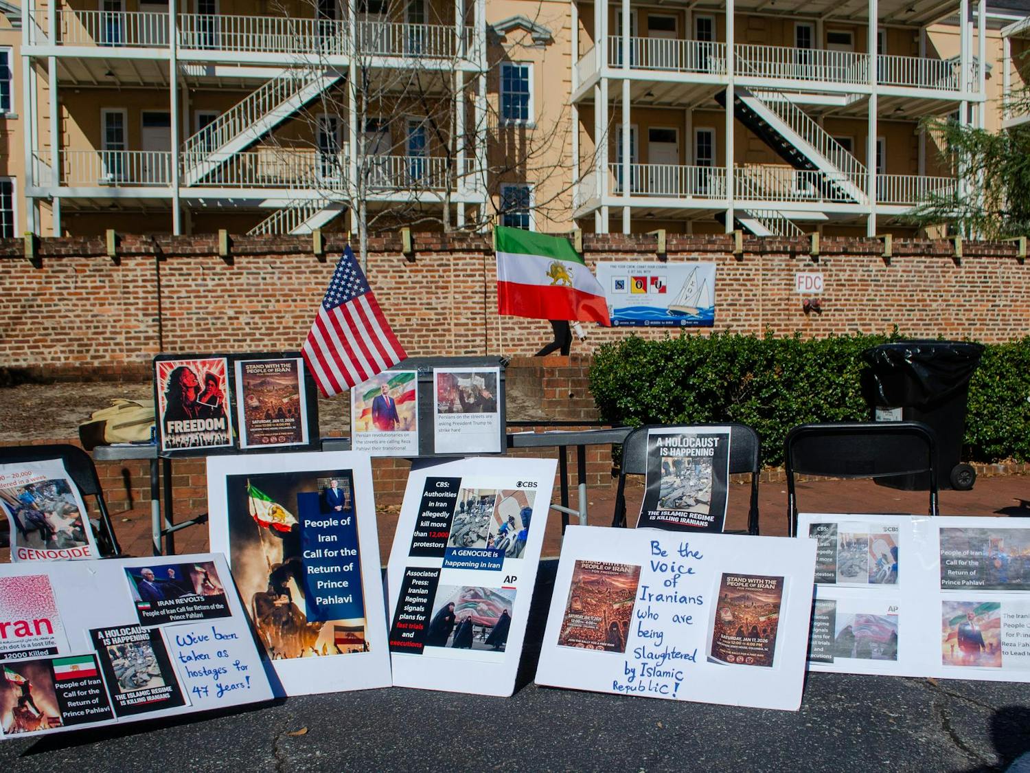 A demonstration in support of protestors in Iran takes place outside the Russell House on Greene Street in Columbia, South Carolina, on Jan. 15, 2026. Signs accuse the Islamic Republic of genocide and support the return of Crown Prince Reza Pahlavi, who is in exile in the United States.
